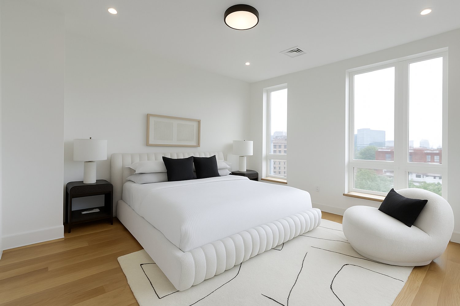Bedroom with 10 ft ceilings and oversized windows at 58 Kent Street, Brookline – luxury condo with natural light and skyline views